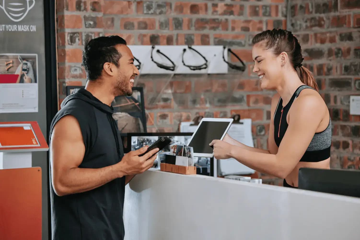 Member signing up at a boutique fitness studio front desk