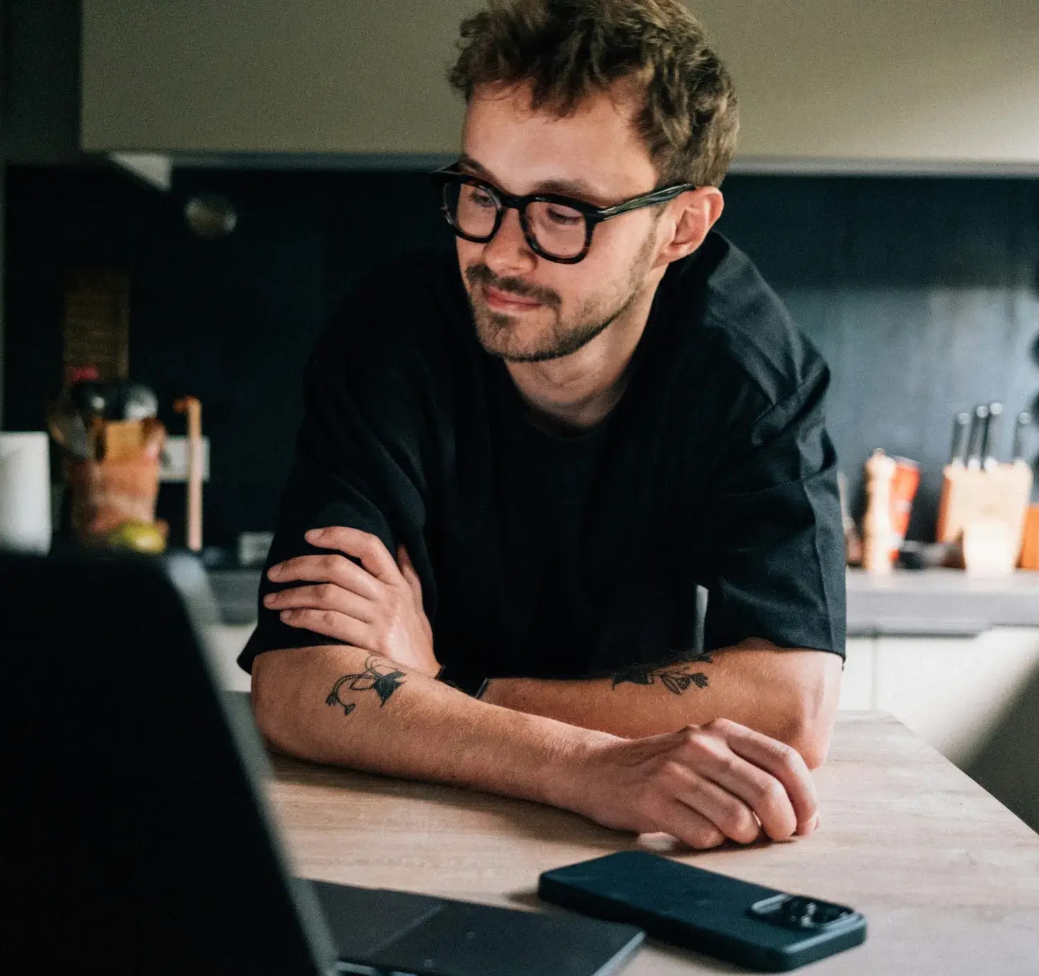 Business owner checking reviews on phone and laptop at the counter