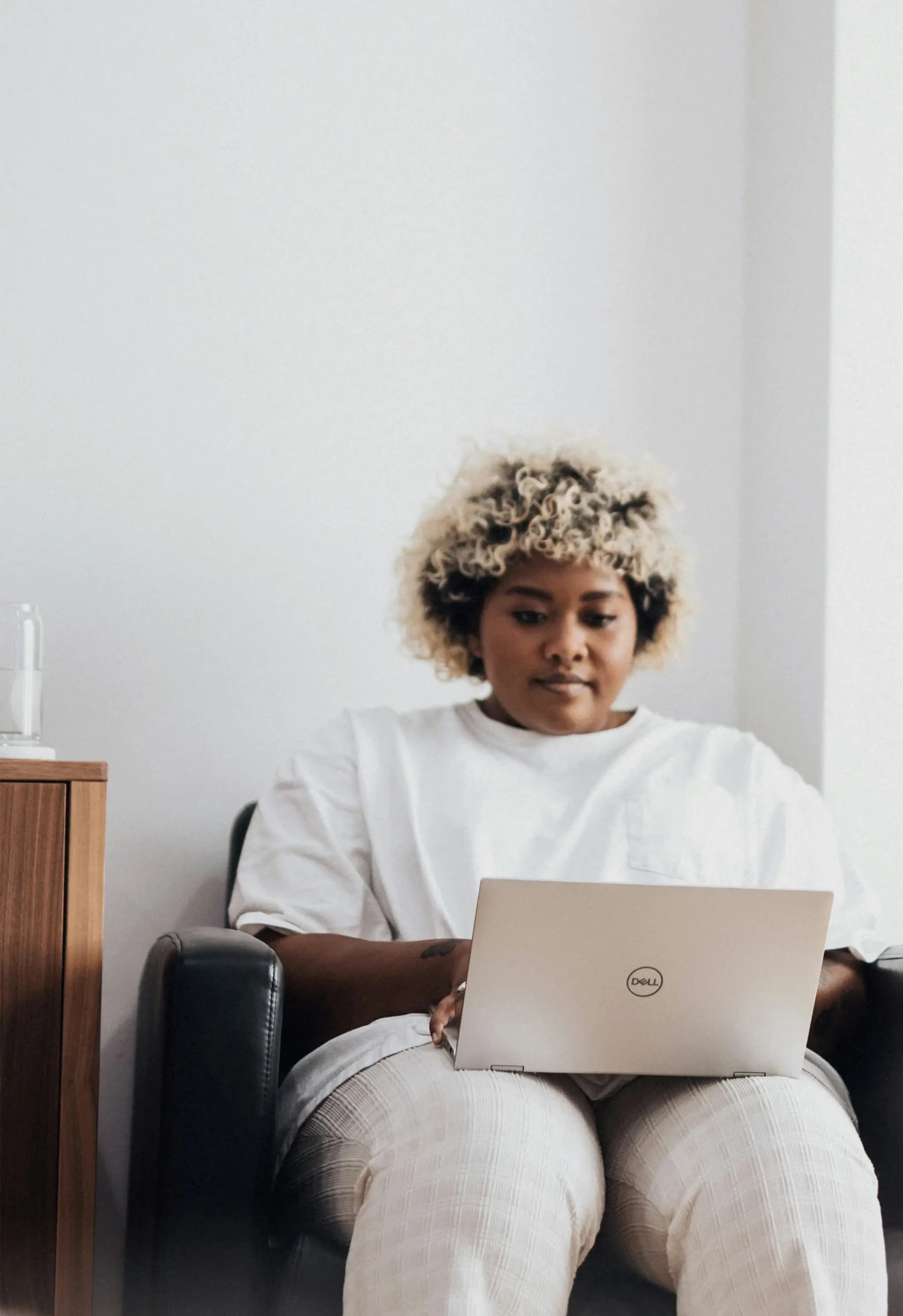 Retail shop owner reviewing customer feedback on a laptop